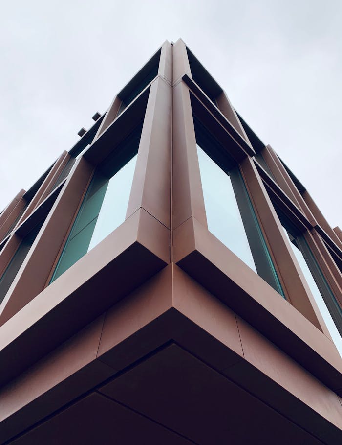 Low-angle view of a modern building with angular design and glass surfaces in Alkmaar, Netherlands.